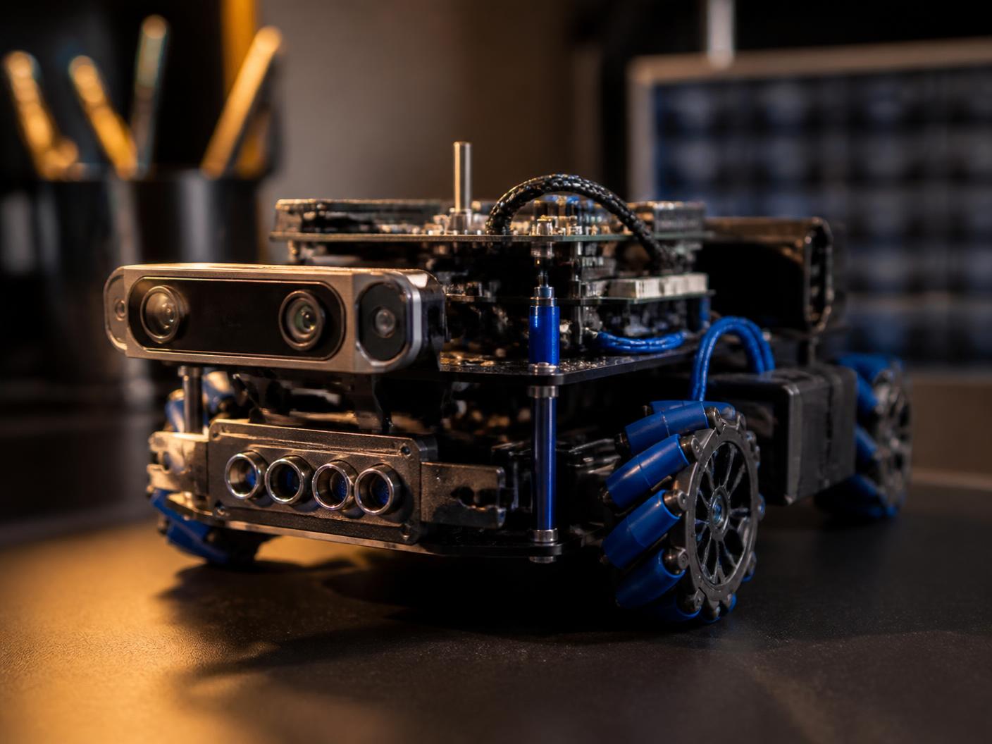 Small autonomous robot prototype with cameras and blue wiring